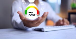 A business person sitting and holding their hand open. A graphic of a money back showing a low-cost scale is in their hand.